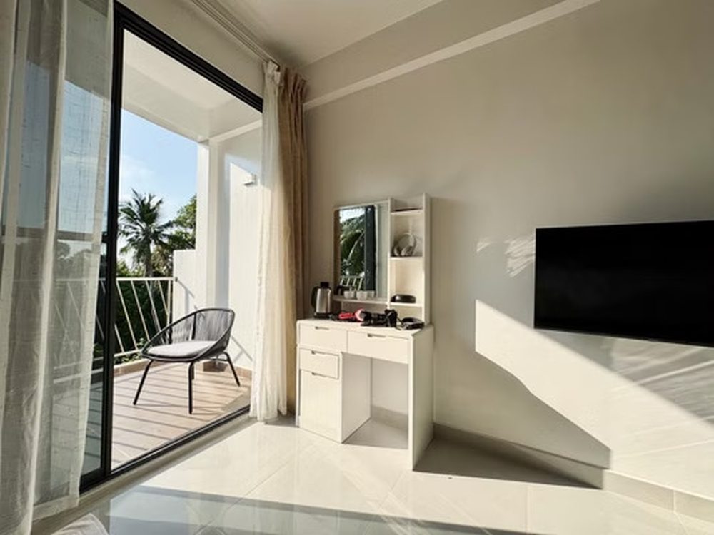 Desk, mirror and television beside the balcony